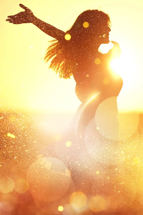 Adrenal-Testing-Treatment A woman with outstretched arms silhouetted by the sunset. Get adrenal testing from Nonkulie Dladla, M.D. in Manhattan.