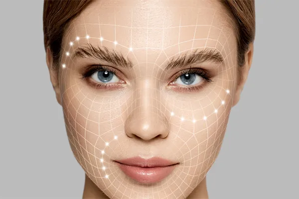 Aesthetic-Fillers-Doctor Close-up of a beautiful face against a gray background, with flowing gridlines illustrated along the cheeks, brow and lips, representing aesthetic filler services from Nonkulie Dladla, M.D. in Manhattan.