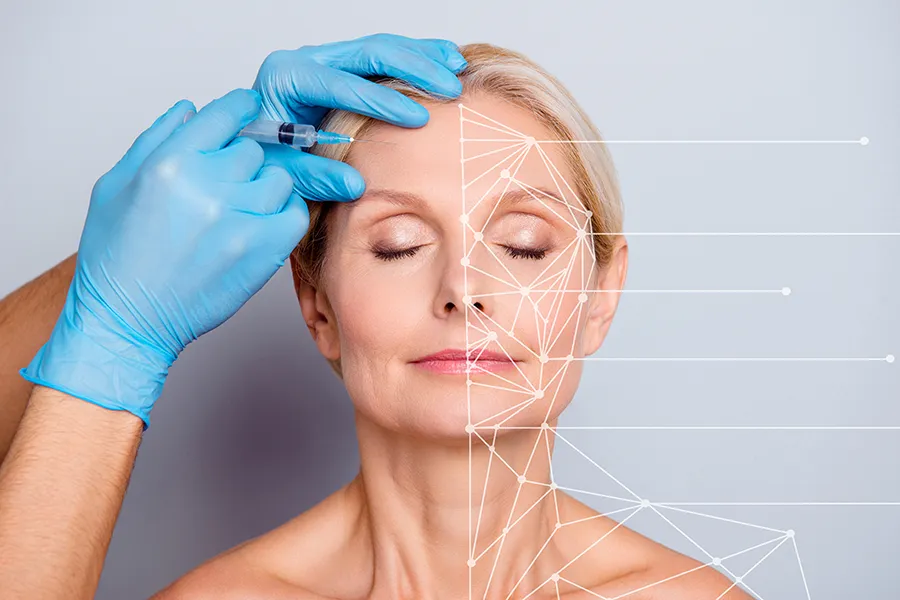 Aesthetic-Injectables-Clinic A mature blonde woman gets a facial injection. Get injectable aesthetic treatments from Nonkulie Dladla, M.D. in Manhattan.