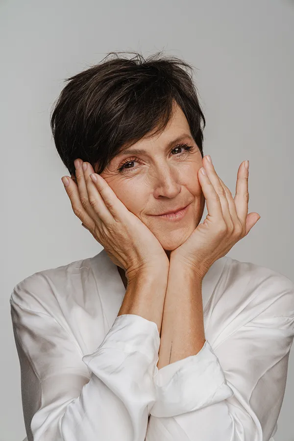 Brain-Fog-Specialist Confident woman smiling with arms crossed, reflecting the renewed mental clarity and confidence patients experience with brain fog treatment by Nonkulie Dladla, M.D. in Manhattan.