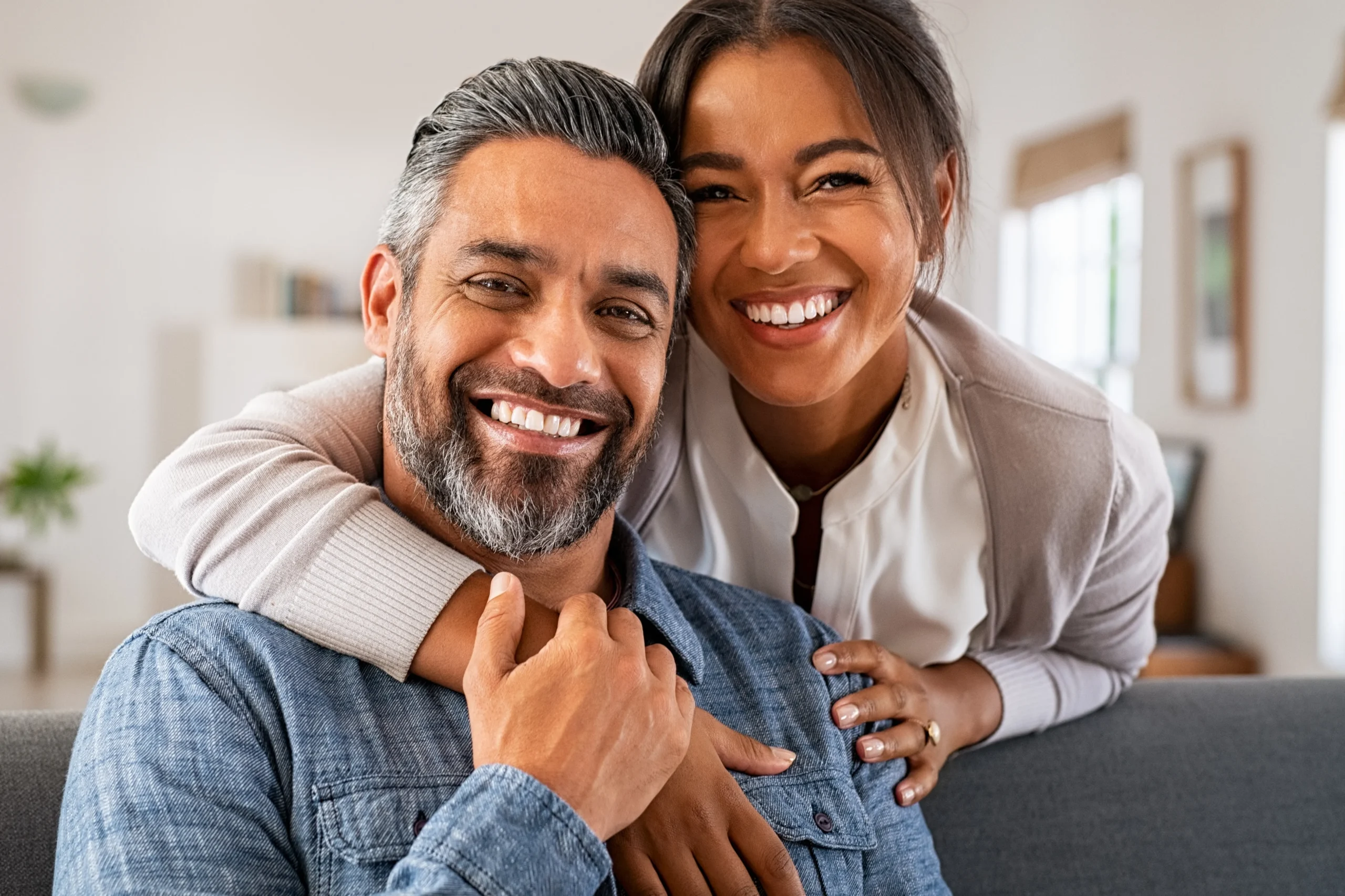 Bioidentical-Hormone-Replacement-Therapy-Clinic-4 A happy middle-aged couple embracing on their couch. Get bioidentical hormone pellet therapy from Nonkulie Dladla, M.D. in Manhattan.