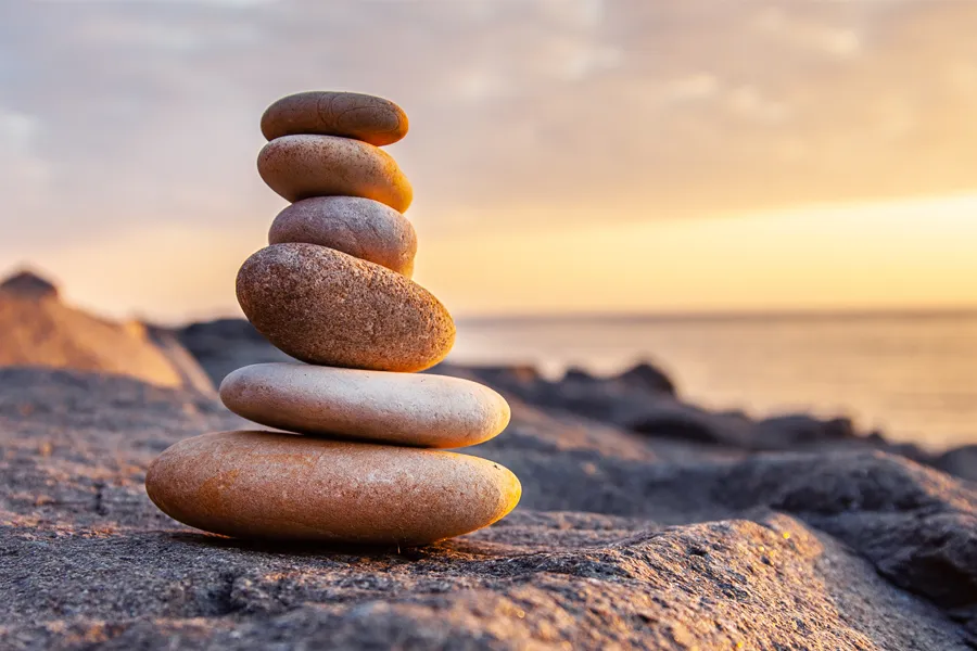 Bioregulatory-Care-Clinic A stack of balanced stones on the ocean shore. Get Bioregulatory Care from Nonkulie Dladla, M.D. in Manhattan.