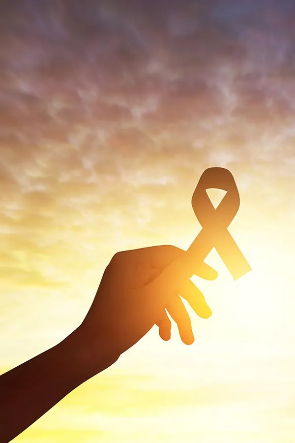 Cancer-Screening-Treatment A handing holding a cancer awareness ribbon. Get a Galleri cancer screening from Nonkulie Dladla, M.D. in Manhattan.