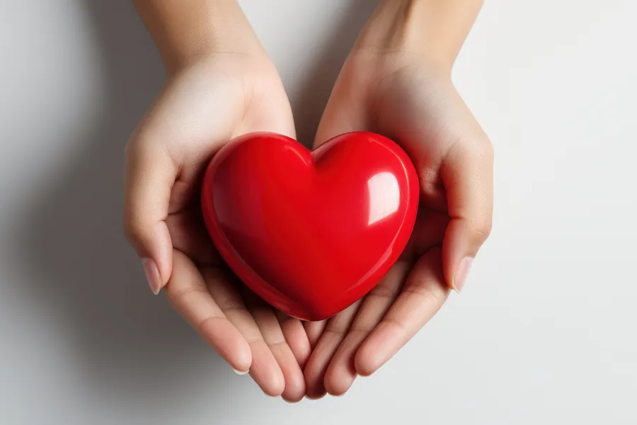 Cardiovasuclar-Care-Clinic A woman holding a heart-shaped object. Get treatment for cardiovascular health from Nonkulie Dladla, M.D. in Manhattan.