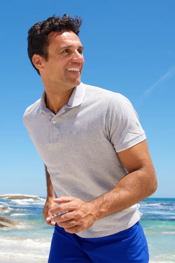 EMSculpt-Muscle-Building-Treatment A muscular man runs on the beach. Get EMSculpt for muscle building from Nonkulie Dladla, M.D. in Manhattan.