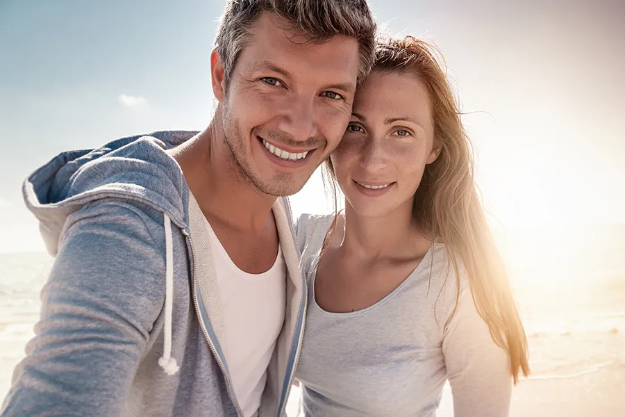 Edetate-Calcium-Disodium-IV-Therapy-Clinic A healthy middle-aged couple in the sun on the beach. Get Edetate Calcium Disodium IV Therapy from Nonkulie Dladla, M.D. in Manhattan.