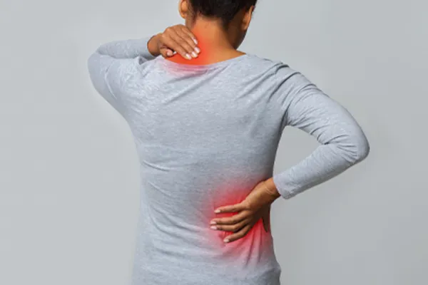 Fibromyalgia-Clinic An image from behind of a woman suffering from Fibromyalgia holding her hands on her neck and lower back. Get fibromyalgia care from Nonkulie Dladla, M.D. in Manhattan.