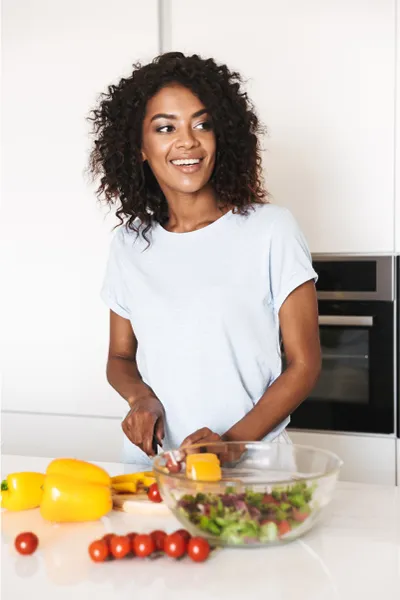 Gut-Repair-Peptides-Treatment A woman prepares a healthy salad. Get Gut Repair Peptides treatment from Nonkulie Dladla, M.D. in Manhattan.