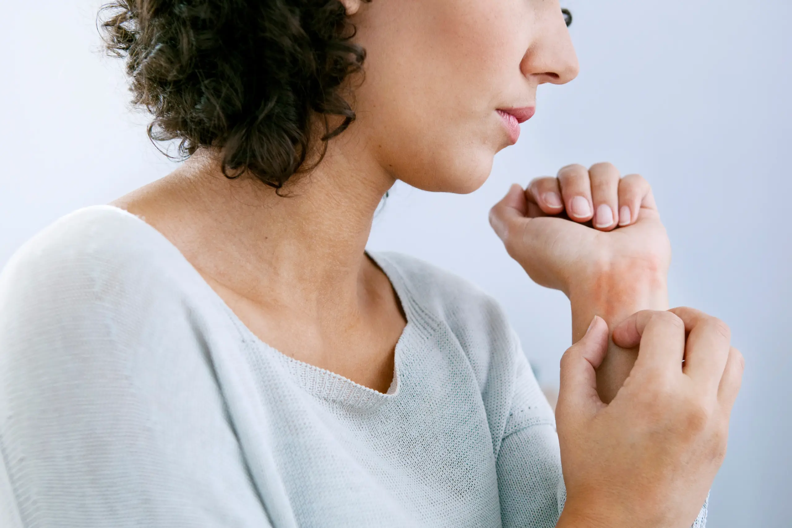Hives-Doctor A woman with curly brown hair and a light gray shirt scratches her wrist due to hives. Get treatment for hives from Nonkulie Dladla, M.D. in Manhattan.