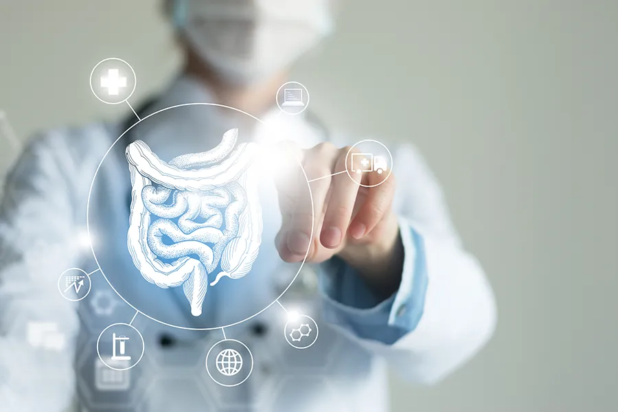 Leaky-Gut-Syndrome-Clinic Nonkulie Dladla, M.D. provides advanced Functional Medicine for Leaky Gut Syndrome treatments in Manhattan, shown by a doctor touching a glowing digital intestinal health display.