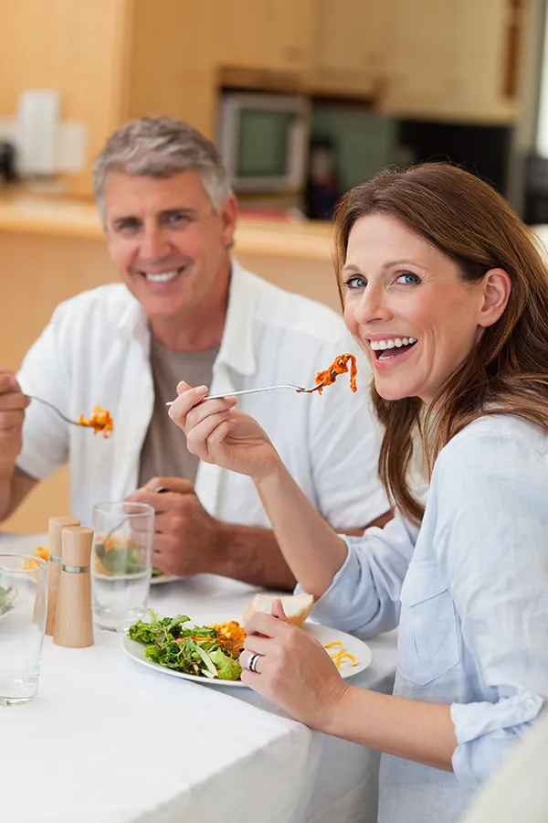 Leaky-Gut-Syndrome-Treatment Improve digestion with Nonkulie Dladla, M.D.'s Functional Medicine for Leaky Gut Syndrome care in Manhattan, featuring a happy couple enjoying a nutritious lunch at home.