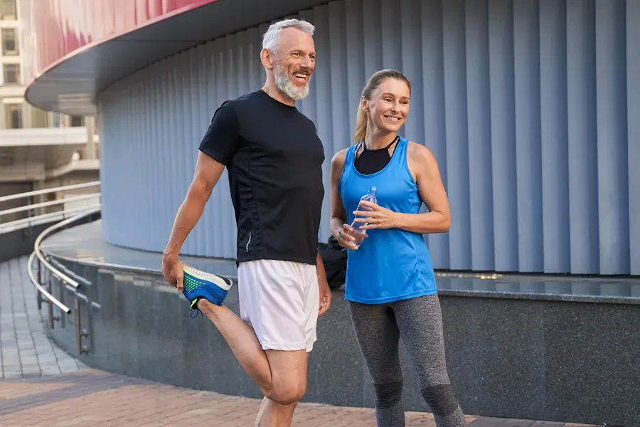 Peptides-for-Healing-and-Recovery-Doctor A middle-aged couple happily stretch and prepare for exercise after receiving effective peptide therapy for healing and recovery from Nonkulie Dladla, M.D. in Manhattan.