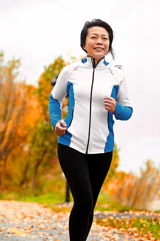 Regenerative-Medicine-for-Inflammation-Treatment A middle-aged asian woman on a run during fall. Get Regenerative Medicine for Inflammation from Nonkulie Dladla, M.D. in Manhattan.