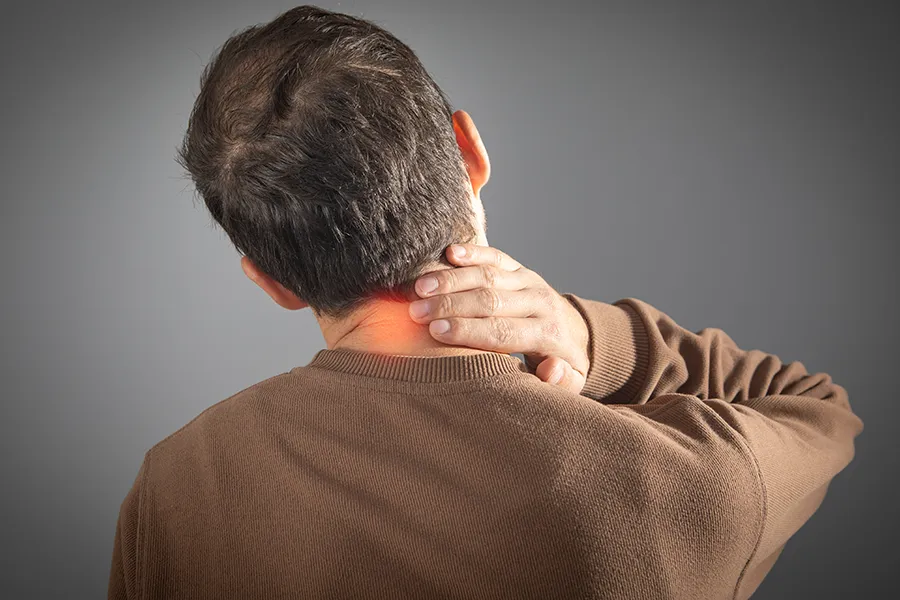 Regenerative-Medicine-for-Neck Pain-Clinic A man rubs his neck in pain. Schedule Regenerative Medicine for Neck Pain from Nonkulie Dladla, M.D. in Manhattan.