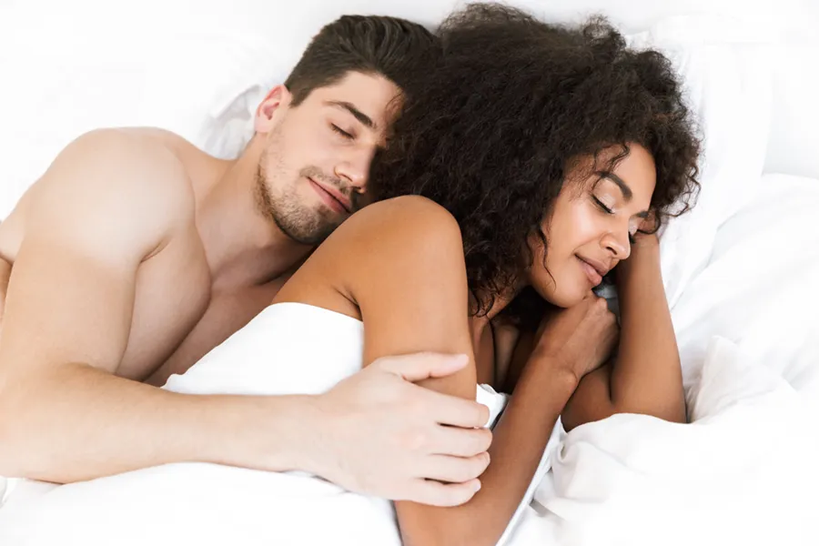 STD-Testing-Clinic A white man and black woman in bed. Get STD testing from Nonkulie Dladla, M.D. in Manhattan.