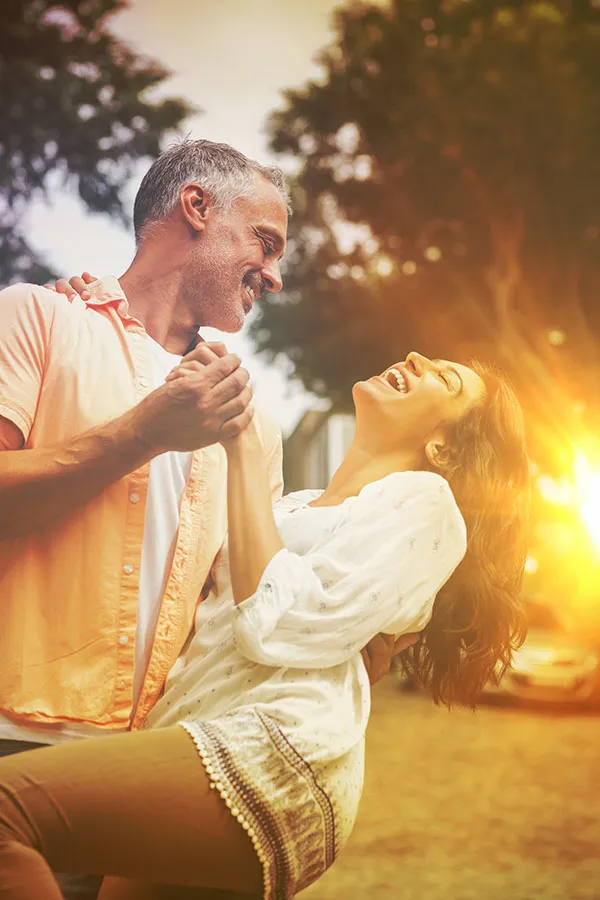 Peptides-for-Healing-and-Recovery-Specialist A middle-aged couple happily stretch and prepare for exercise after receiving amazing peptide therapy for healing and recovery from Nonkulie Dladla, M.D. in Manhattan.