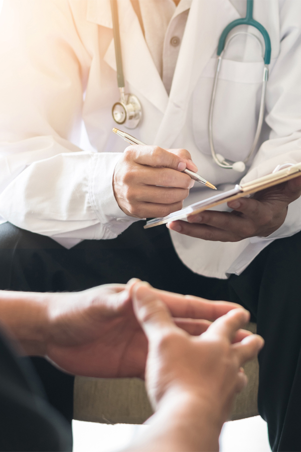 Specialist-Referral-Treatment A specialist takes notes while speaking with a patient. Get High-end Specialist referrals from Nonkulie Dladla, M.D. in Manhattan.