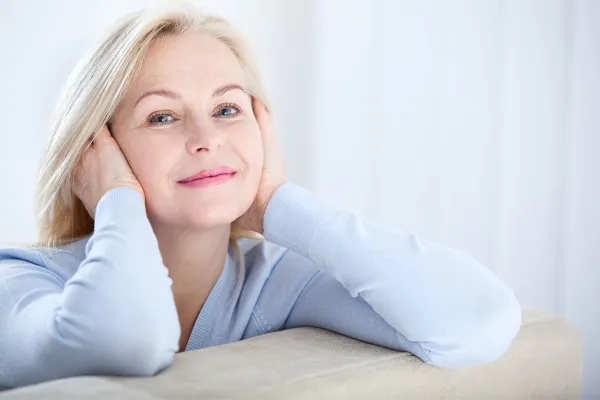 Stem-Cell-Facial-Clinic A beautiful middle-aged blonde woman rests her head in her hands. Schedule stem cell facial treatment from Nonkulie Dladla, M.D. in Manhattan.