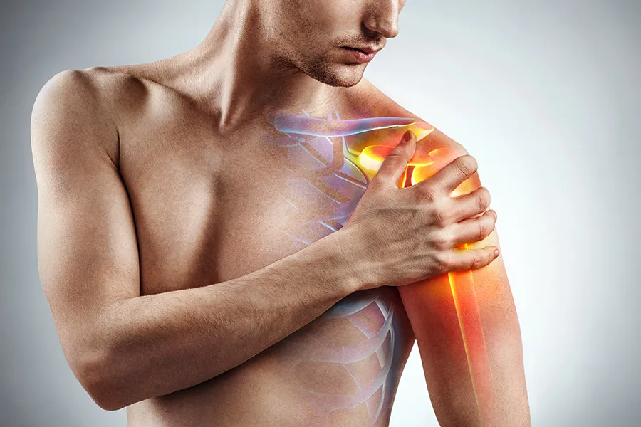 Stem-Cells-for-joint-Pain-Clinic A man holds his shoulder, highlighted in red, in pain. Schedule stem cells for joint pain from Nonkulie Dladla, M.D. in Manhattan.