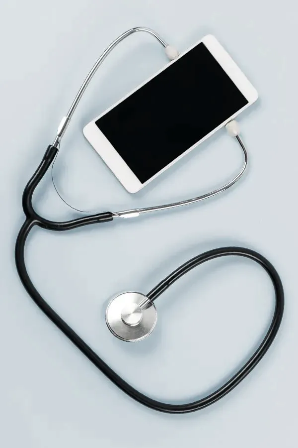 Telemedicine-Treatment A smartphone with a stethoscope attached to it, symbolizing Telemedicine treatment from Nonkulie Dladla, M.D. in Manhattan.