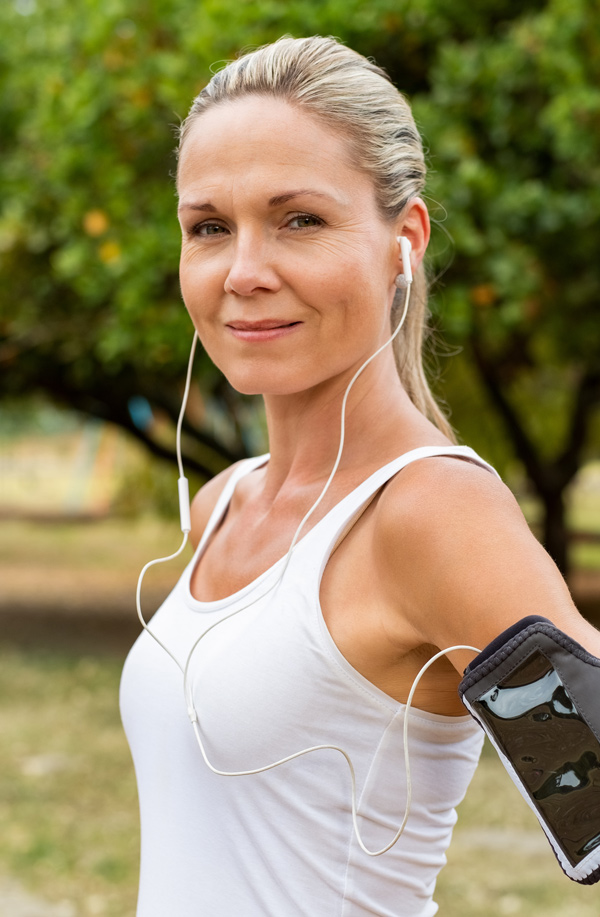 fibromyalgia-doctor Middle-aged, active woman taking a break to smile at the camera during a run, representing successful Bioidentical Hormones for Fibromyalgia Relief offered by Nonkulie Dladla, M.D. in Manhattan.